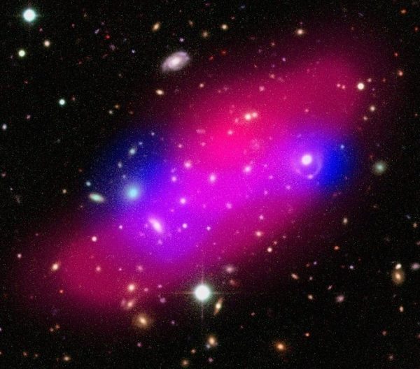 Composite image of the Bullet Group showing galaxies, hot gas (shown in pink) and dark matter (indicated in blue). Image credit: ESA / XMM-Newton / F. Gastaldello (INAF/IASF, Milano, Italy) / CFHTLS