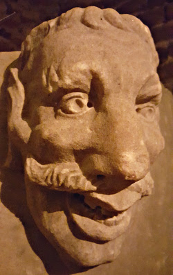 One of four grotesque male faces on a 17th century object in the Tre Kronor castle museum. The piece looks like a little baptismal font, but the label says "possibly a kitchen mortar". Neither function seems likely.