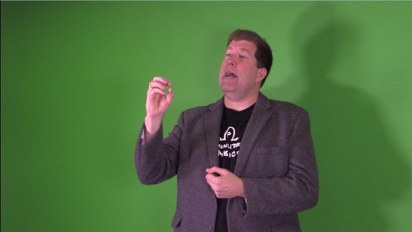 Me in front of a green screen making a dramatic gesture.