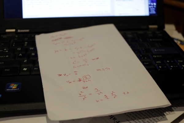 Scratch paper with calculations for a football physics post at Forbes.