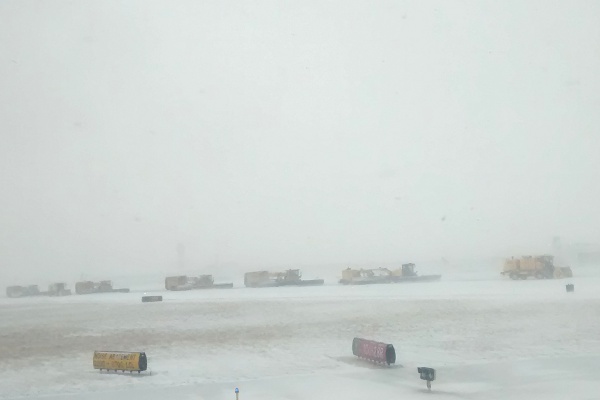 Snow removal trucks on the runway at O'Hare International Airport.