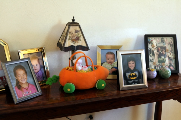 The photo shelf in my parent's living room, with school pictures of the kids.