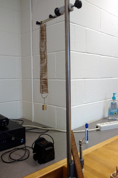 The hanging spring for the lab I'm working on, fortuitously aligned with the corner of the wall behind it.