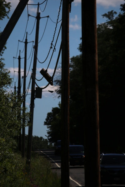 The hanging remains of a broken telephone pole in Niskayuna.