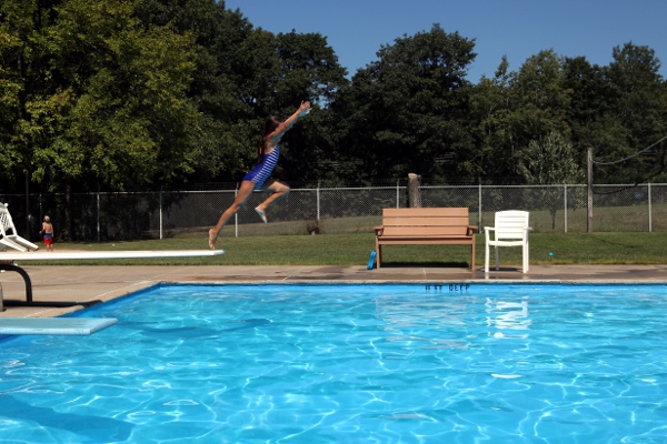 SteelyKid going off the diving board at the Niskayuna town pool.