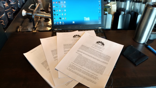 The traditional photo of a pile of signed contracts for a new book, just before mailing them.