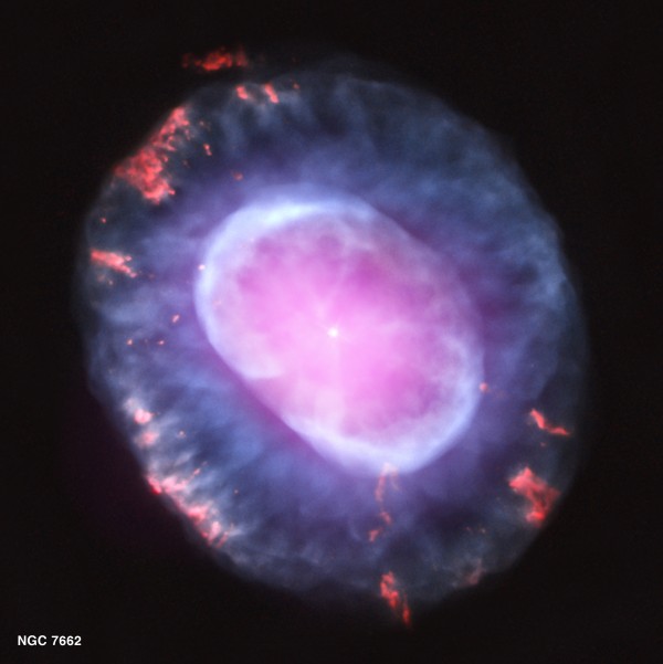 A planetary nebula represents a phase of stellar evolution that the Sun should experience several billion years from now. When a star like the Sun uses up all of the hydrogen in its core, it expands into a red giant, with a radius that increases by tens to hundreds of times. In this phase, a star sheds most of its outer layers, eventually leaving behind a hot core that will soon contract to form a dense white dwarf star. A fast wind emanating from the hot core rams into the ejected atmosphere, pushes it outward, and creates the graceful, shell-like filamentary structures seen with optical telescopes. It also looks like an exploding brain. Image credit: NASA / CXC.