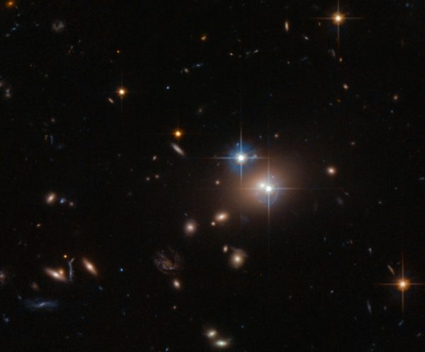 The Twin Quasar QSO 0957+561, as gravitationally lensed by the enormous elliptical galaxy, YGKOW G1, four billion light years away. This was the first gravitational lens ever discovered, in 1979. Image credit: ESA/Hubble & NASA.