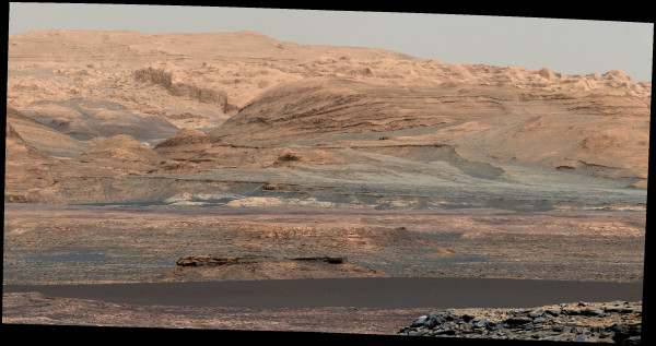 A full-color view of the rocky terrain of Mount Sharp, with the darker, lower dunes in the foreground. Image credit: NASA / JPL-Caltech / MSL Curiosity Rover.