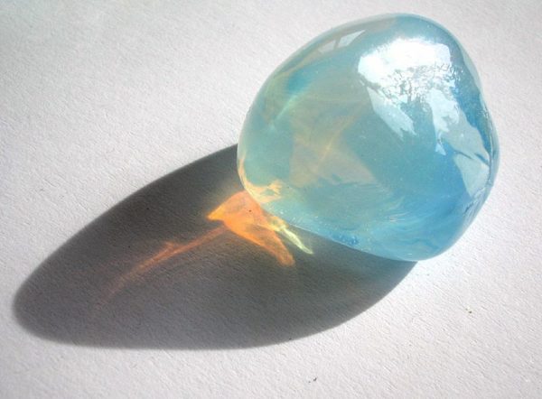 The Tyndall effect in opalescent glass, where the glass appears blue in the light, but allows orange light through. Image credit: flickr user optick under a c.c.-by-s.a. 2.0 license. Via http://www.flickr.com/photos/optick/112909824/.