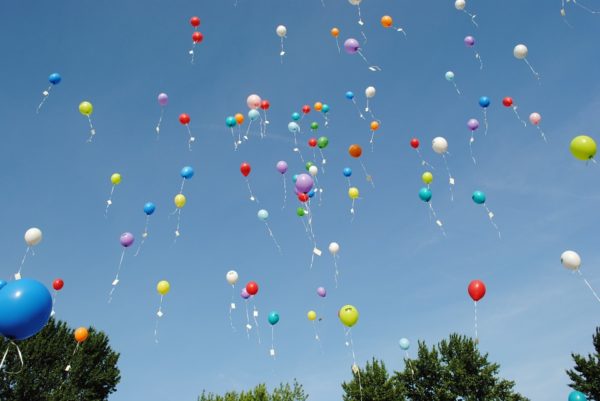 Helium balloons, where the vast majority of the helium inside will escape the Earth. Image credit: public domain photo from Pixabay user HilkeFromm.