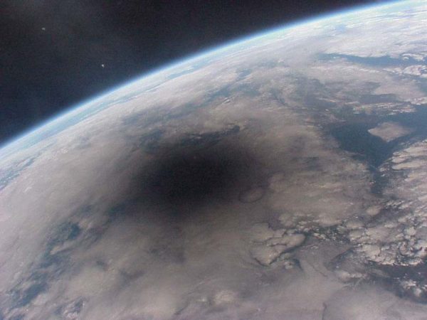 Image credit: Mir / RSA, 1999, of the Moon's shadow falling on Earth, during a total solar eclipse as seen from space.
