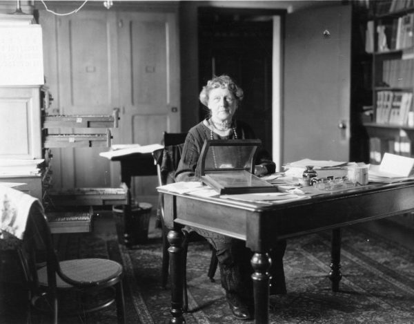 Annie Jump Cannon sitting at her desk at Harvard College Observatory, sometime in the early 20th century. Image credit: Smithsonian Institution from the United States.