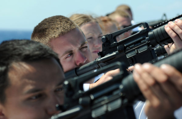 Naval soldiers prepare to fire a gun salute during a burial at sea. This would be catastrophically unsafe in any region where the bullets could come down and land on a human. Image credit: U.S. Navy photo by Mass Communication Specialist 3rd Class Kevin J. Steinberg.