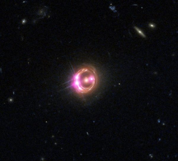 An ultra-distant quasar showing plenty of evidence for a supermassive black hole at its center. How that black hole got so massive so quickly is a topic of contentious scientific debate, but may have an answer that fits within our standard theories. Image credit: X-ray: NASA/CXC/Univ of Michigan/R.C.Reis et al; Optical: NASA/STScI.