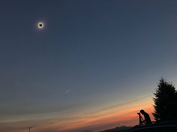 The eclipsed Sun, the visible corona, and the reddish hues around the edges of the Moon's shadow — along with human beings rapt with awe — were among the most spectacular sights of the total eclipse. Image credit: Joe Sexton / Jesse Angle.