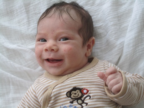 Miles smiling, 3 weeks old